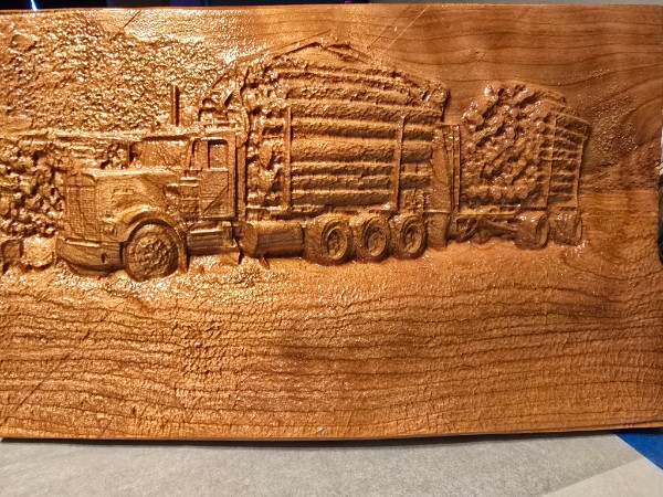 Carved wood relief of a logging truck