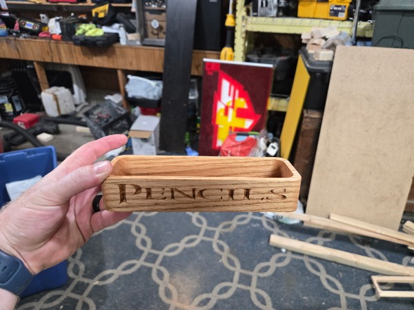 Small engraved desk nameplate being held in a shop